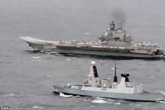 The bear in our backyard: Return of the Cold War as Royal Navy confronts Russian aircraft carrier group in the English Channel for the first time in years